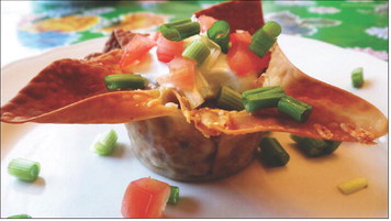 PARTY PREP Taco cups in muffin tins can be created by brushing egg-roll or wonton wrappers with oil to crisp in the oven, eliminating the need to for deep frying. | ANGELINA LaRUE PHOTO