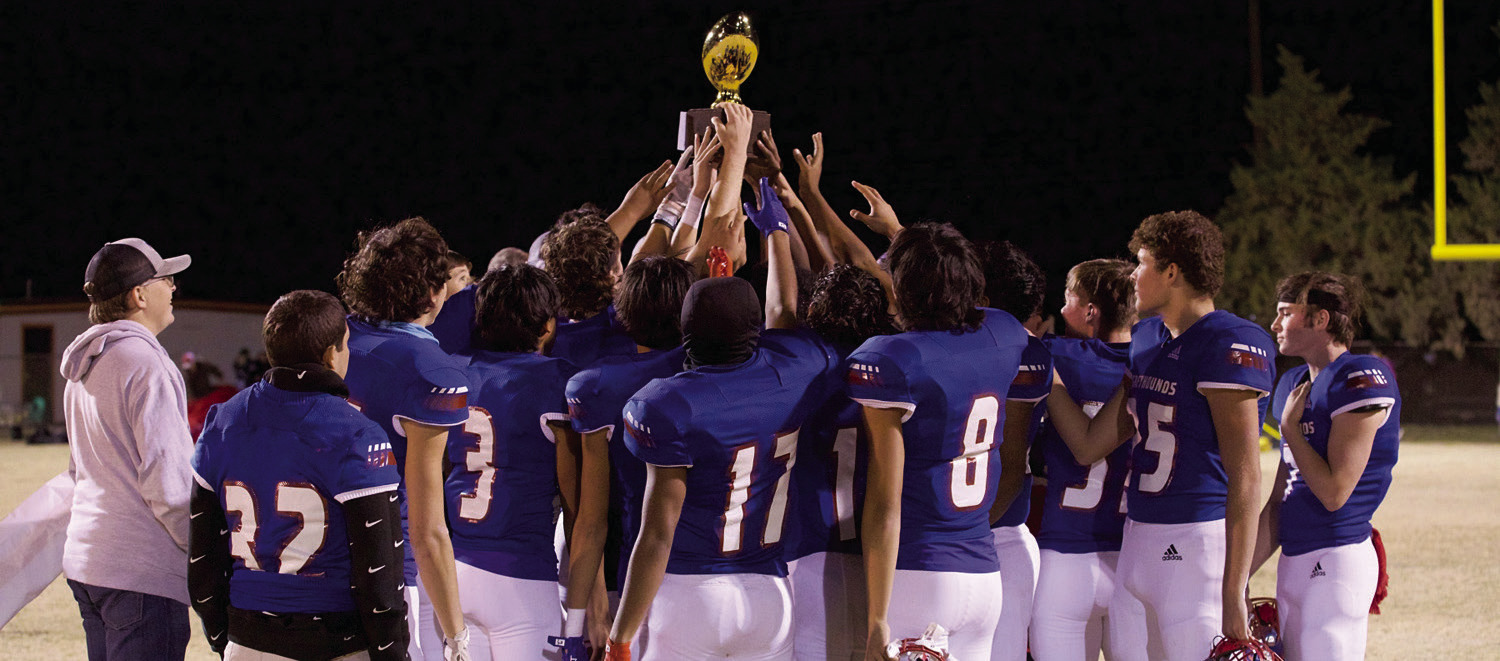 CHAMPS The Greyhounds raise the Bi-District championship trophy. | SHERI BATY PHOTO