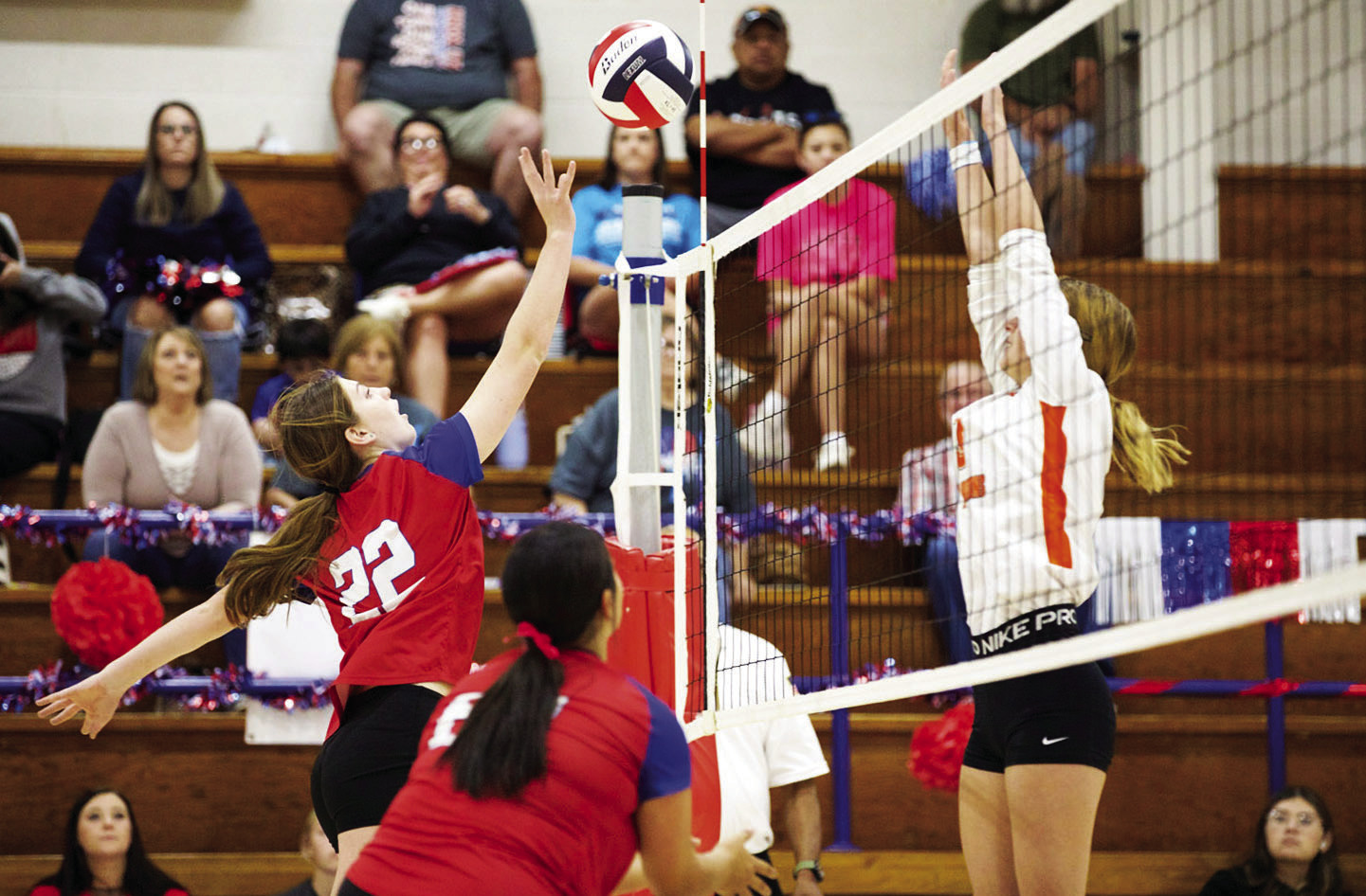 HOUNDETTES VOLLEYBALL Grayson Utley hits the ball over the net despite Paducah's attempted block. | SHERI BATY PHOTO