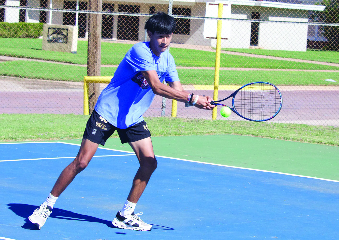 JoeAdamMorelosreturnstheballintheboysdoublesmatch.| SHERI BATY PHOTO