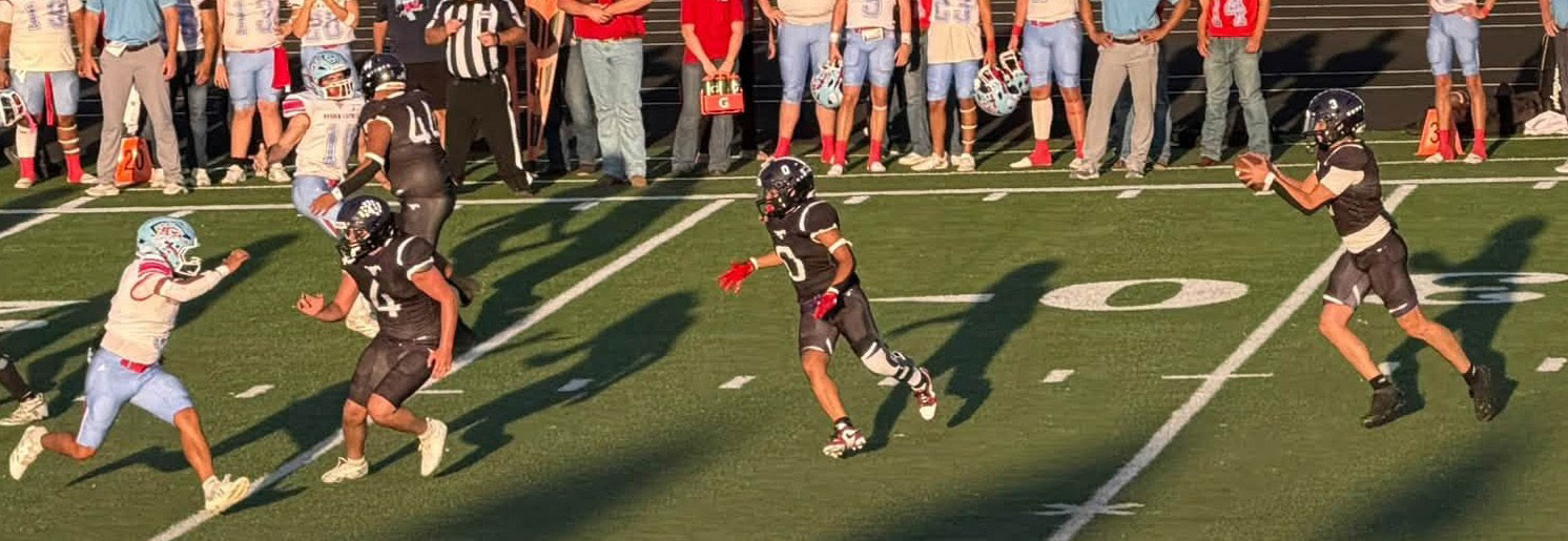 LOOKING AHEAD The Mustang spreadback looks for someplace to run as the Borden County Coyotes rush to a 66-16 win over Benjmain on their home field. | COURTESY PHOTO