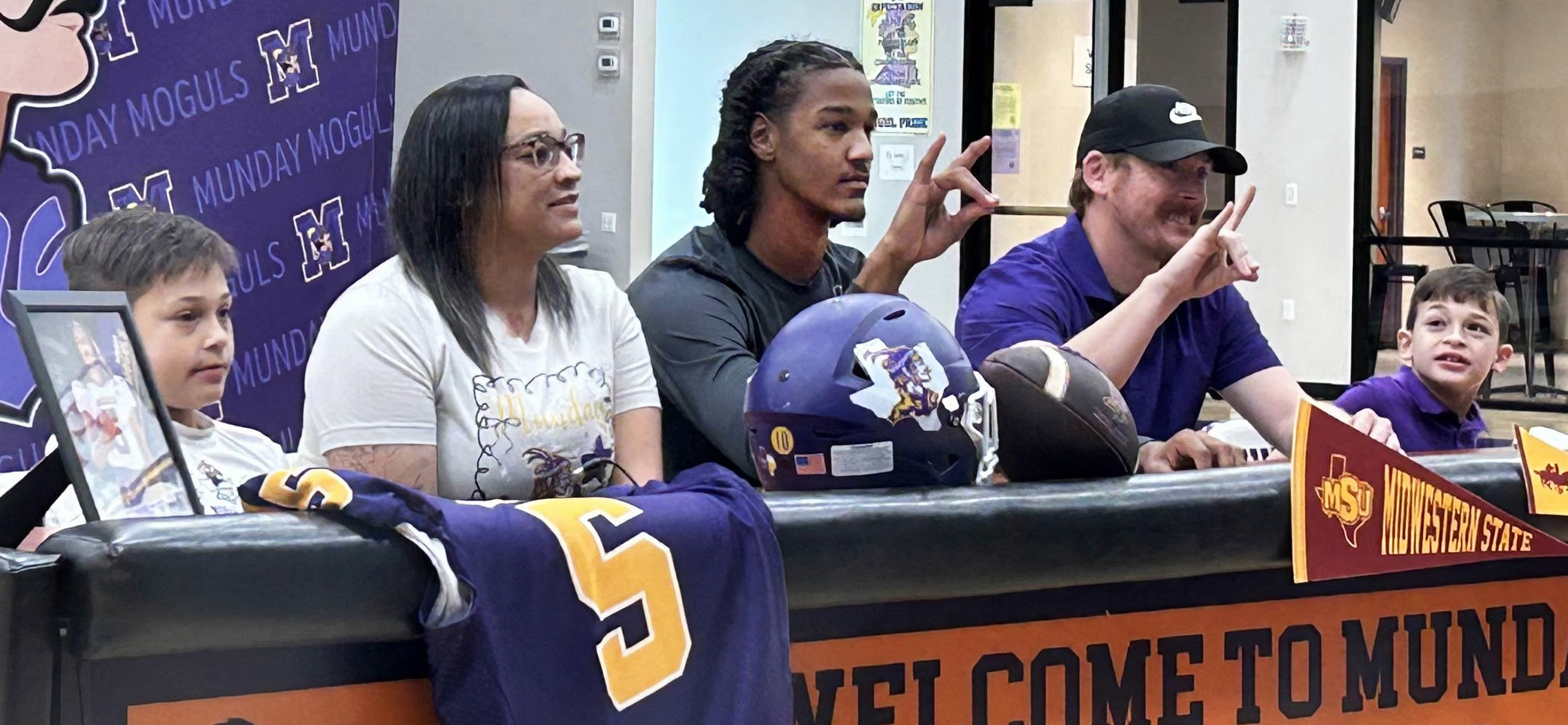MOGULTO MUSTANG As he signed his letter of intent to play football for Midwestern State University, Ja’Riyis Williams (center) was surrounded by his mother, Shadee, stepfather, Ryan, and his two younger brothers. | COURTESY PHOTO