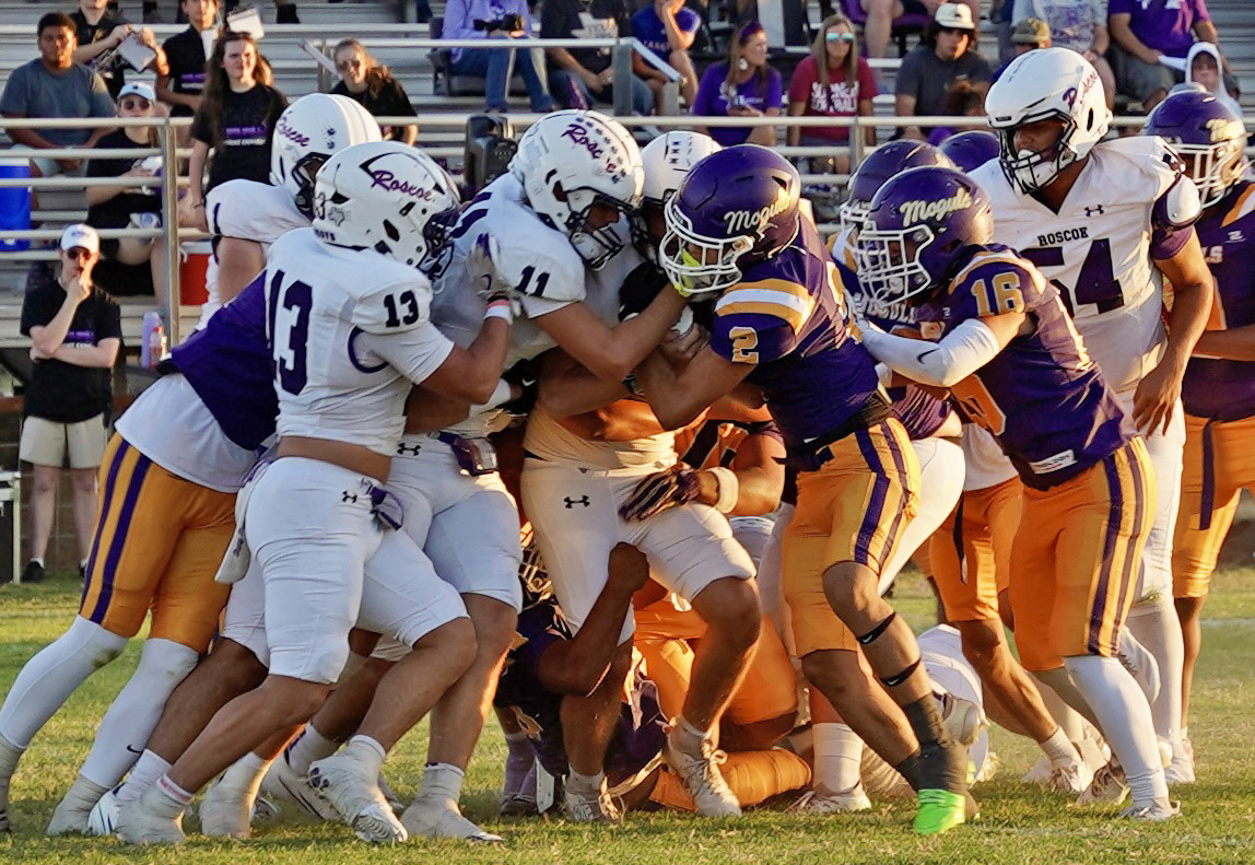 MASS OF MOGULS converged on a Roscoe running back and prevailed—eventually—over the Plowboys in Munday’s Homecoming football game Sept. 11. With both teams scoreless going into the second half, Munday broke things open to claim the win, 21–0. | LACI BOWMAN PHOTO