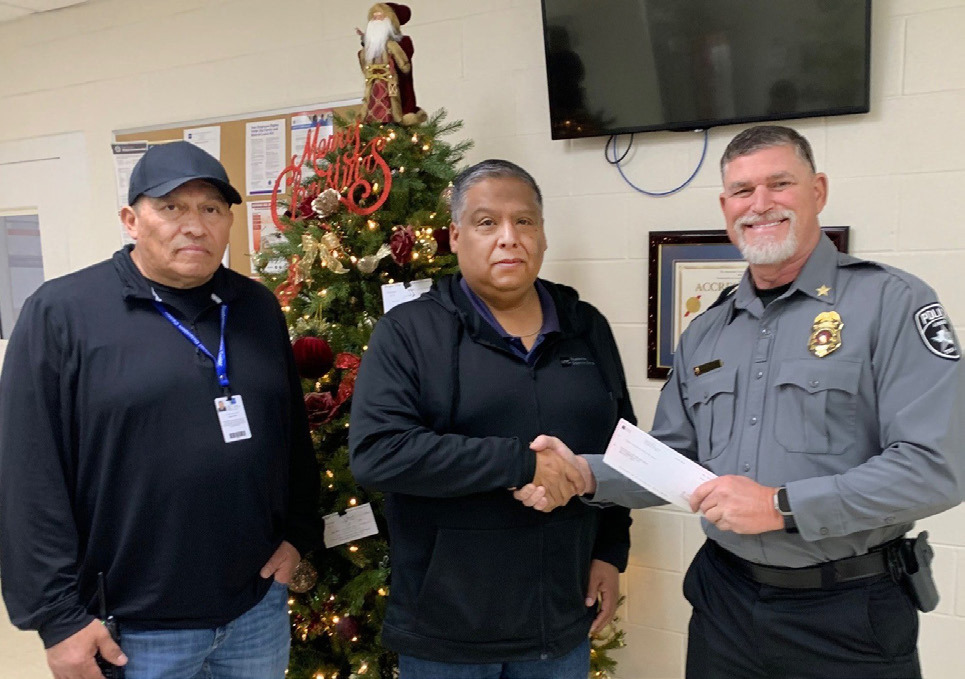 2025 BLUE SANTA DONATION Bluebonnet Detention Center recently donated $750 to the Anson Police Department’s Blue Santa Program. From left, BDC Deputy Warden Leandro Hernandez, BDC Warden Marcello Villegas and Anson Police Chief Dan Graziose participated in the presentation. | COURTESY PHOTO