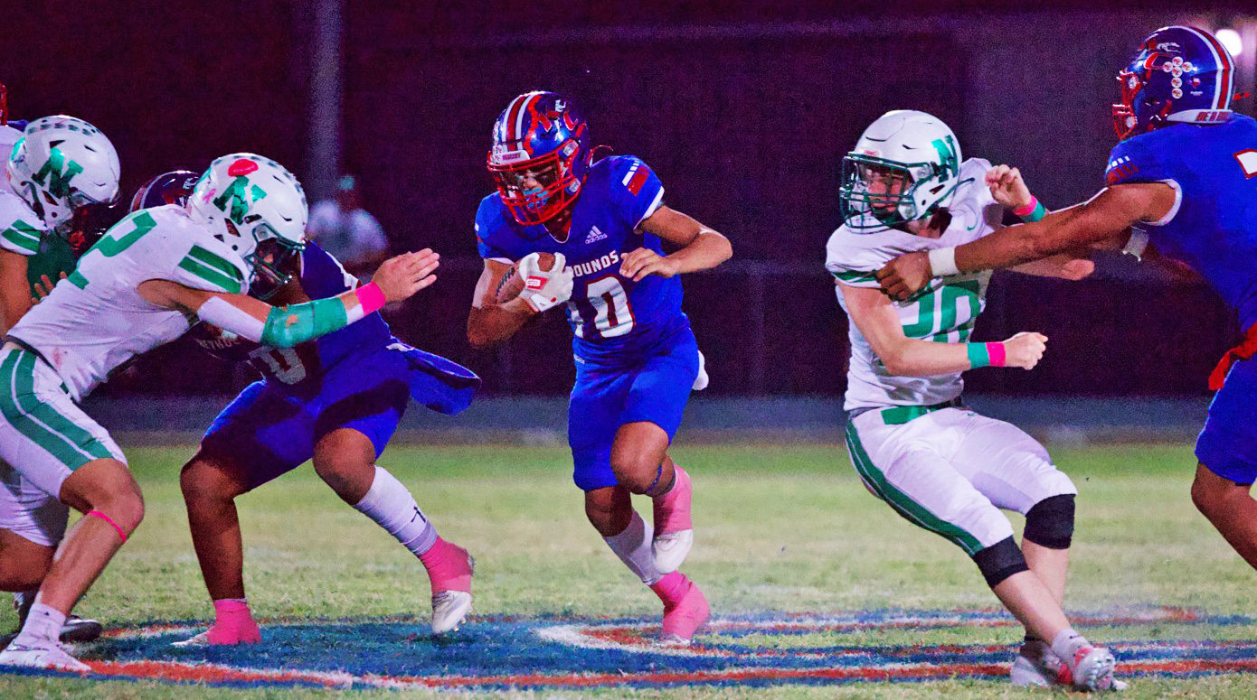 THROUGHTHE OPENING Hunter Lerma finds the hole and runs through the Newcastle defense in what ultimately results in a heartbreaking Greyhound loss. | SHERI BATY PHOTO