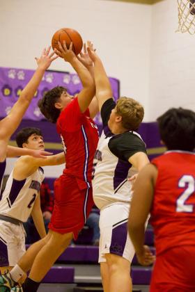 GREYHOUNDS DOMINATE Knox City’s Chase Rowland reaches for the rim as the Greyhounds dominate Throckmorton last weekend. | SHERI BATY PHOTO