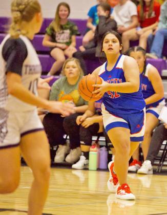 LOOKING FOR AN OPENING Houndette Miley Arrietta looks down court for a clear opening. the Houndettes traveled to Throckmorton for one game over Thanksgiving break. Throckmorton controlled the game from the beginning. The Houndettes put forth a valiant charge late, butThrockmorton won the game 52-38. | SHERI BATY PHOTO