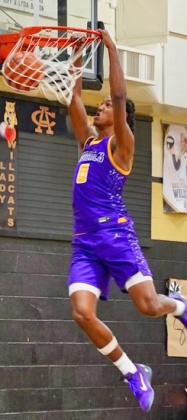 DUNKING IT IN Munday Mogul Ja’Riyis Williams dunks one in against Archer City in last week’s game. | LACI BOWMAN PHOTO