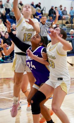 BATTLE UNDER THE BASKET Aaralyn Taylor battles under the basket for a rebound during last week’s game against Perrin-Whitt.