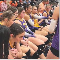 Munday players listen to Coach Burns during a timeout in Tuesday night's bi-district match with Rotan. | SUE JANE SULLIVAN PHOTO