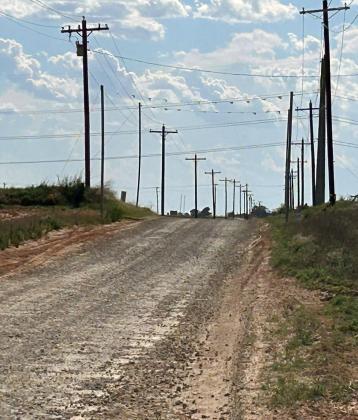 WATCH OUT OVERHEAD Signs and banners warn drivers of overhead powerlines on CR 4460 west of Munday, near the Rhineland water tower.