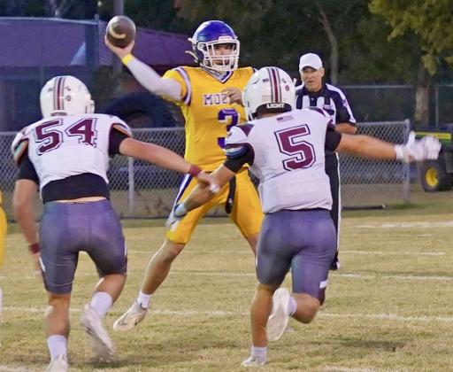 PASS COMPLETED Munday’s Haiden Bowman completes a pass to Caisen Lee under pressure in Friday night home game against Seymour. | LACI BOWMAN PHOTO