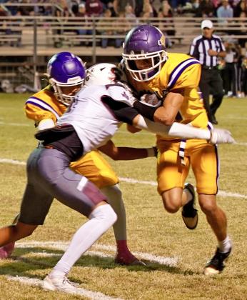 PUSHING PAST THE DEFENSE Luke Bowman of Munday carries the football and pushes past the Seymour defense. | LACI BOWMAN PHOTO