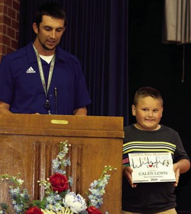 KC ELEMENTARY PRINCIPAL Jordan Carter proudly presents first graderCalenLewiswiththeLyndonBatyMemorialLive,Love,Read like Lyndon Award which encourages children to live life to the fullest, love one another, and develop a lifelong love of reading like Lyndon Baty. | SHERI BATY PHOTO