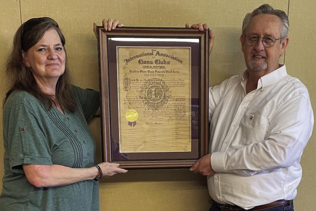 LIONSCLUBCHARTER Lions Club Secretary/Treasurer Rhonda Rogers and President DonThompson proudly display the important document. | JIM COWSERT PHOTO