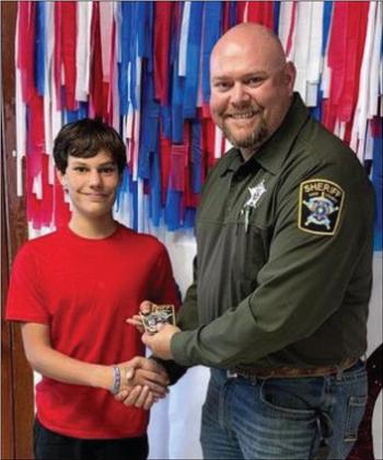ALL GOOD DEEDS Deputy Sheriff Bridger Bush presented an award to KCJH 8th grader, Bryson Shelton for being a good citizen. Bryson was caught doing a good deed for the community last week.