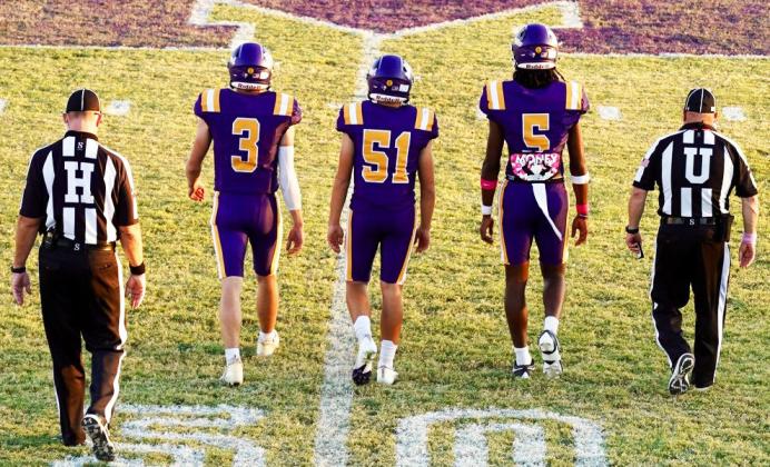 CAPTAINS MEETING Team Captains Haiden Bowman, Carson Breedlove, and Ja’RiyisWilliams meet at midfield for the coin toss. | LACI BOWMAN PHOTO
