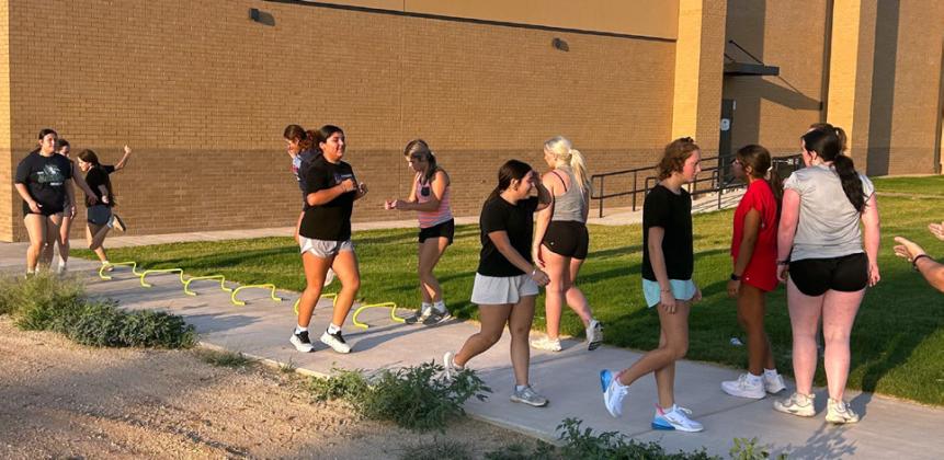 AGILITY DRILLS help build team speed and agility. Head volleyball coach Cody Propps works out his team outside, taking advantage of cool temps Aug. 3.