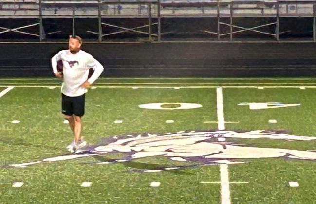 NEW HEAD COACH Aaron KueherlooksonashisBenjamin Mustangs run through drills during the 5 a.m. practice Aug. 3.