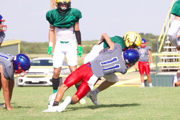 TAKING DOWN THE CAT KC Greyhound Izaiah Trevino brings down the Guthrie Jaguar in the backfield. PHOTOS BY SHERI BATY
