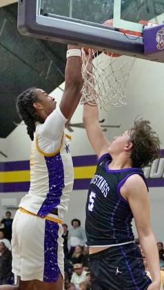HARDTOTHE RIM Munday’s Ja’Riyis Williams takes the ball hard to the rim in lastTuesday’s, Jan. 20, matchup against the Benjamin Mustangs. Munday and Benjamin entered the game tied for first place in the district standings. | LACI BOWMAN PHOTO