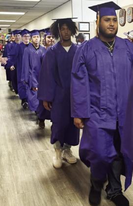 MUNDAY GRADUATES WALK HALLWAYS