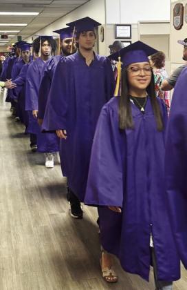 MUNDAY GRADUATES WALK HALLWAYS