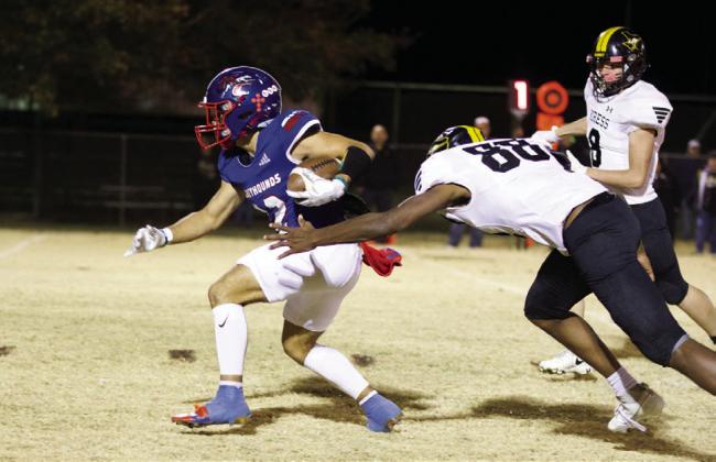 RUSHING Cameron Hernandez slips through the grip of the Kress defender and runs for the TD. | SHERI BATY PHOTO