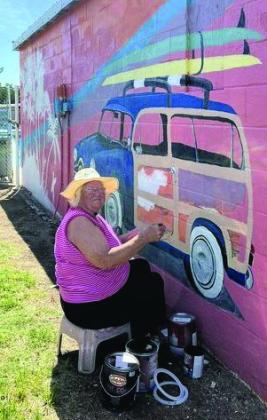 JEANIE JOHNSON PAINTS and creates beauty at the Munday Pool. Jeanie is touching up some of the pool art and is going to do her very own original painting on the right side of the pool. | COURTESY PHOTO
