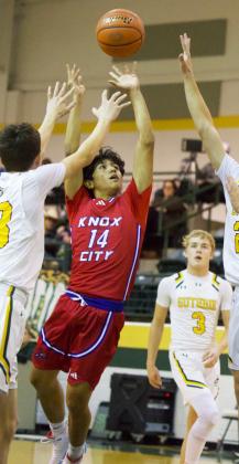 EYEING THE HOOP Jaidev Casarez has his eye on the hoop as he tries to escape Guthrie players.