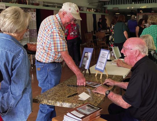 C.H. Underwood signing copies of his book “A History of the Upperforks of the Brazos River”. Photo by Sherry Hacker
