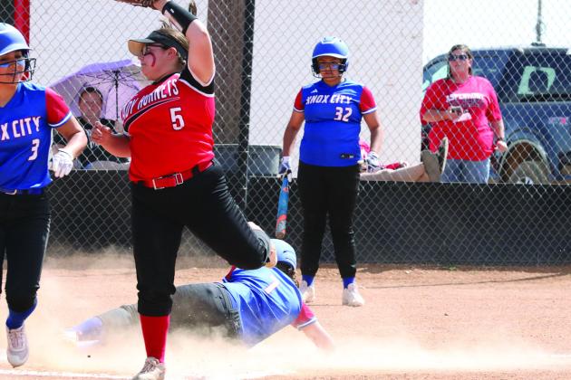 Devon Hernandez slides home and scores Sheri Baty/The Knox County News-Courier