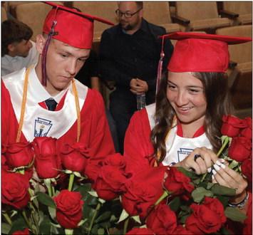 Gage Morrow and Callie Grimsley pick their roses to share with their loved ones at the KCHS graduation ceremony Sheri Baty/The Knox County News-Courier