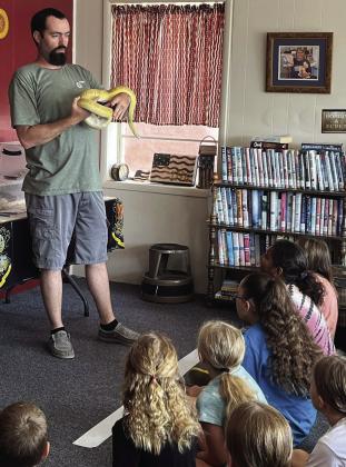 CARING FOR MAGICAL CREATURES Michael Burbank from Burbank’s Reptiles and Exotics brought some of his snakes and geckos to the Munday City-Library Summer reading program. Burbank showed the group how to care for these amazing and magical creatures. | AMANDA BURBANK PHOTO