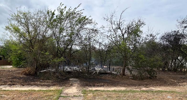 AFTERMATH OF EARLY MORNING FIRE All that remains of the home at the intersection of Munday Avenue and E Street. Trees blocked access to the structure. | TROY PARTON