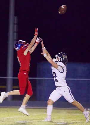 UNDER PRESSURE Knox City’s Bently Stroud, under pressure, makes the reception for the touchdown. Greyhounds controlled the game against the Perrin-Whitt Pirates, resulting in their first district win of the season with a final score of 44-30 at home. | SHERI BATY PHOTO