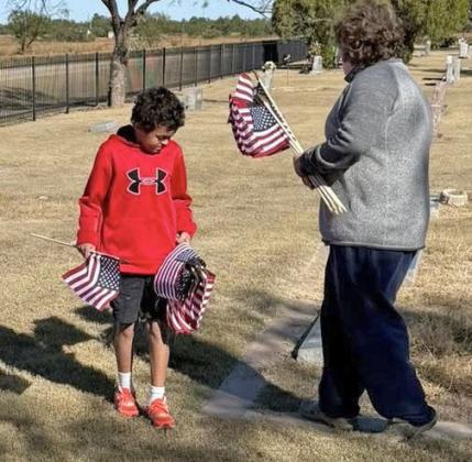 DAY Someofthestudentsfrom Benjamin Junior High School were out over the weekend placing flags on the graves of veterans at the cemetery in preparation of Veterans Day. | COURTESY PHOTOS