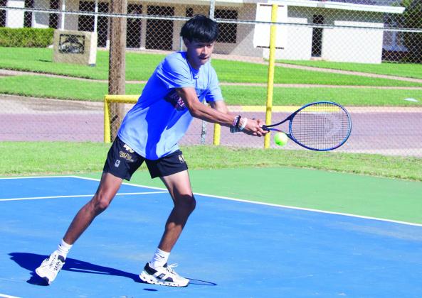 JoeAdamMorelosreturnstheballintheboysdoublesmatch.| SHERI BATY PHOTO