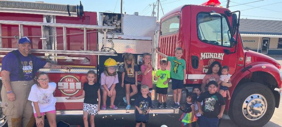 Munday volunteer firefighter Michael Loper and children who attended fire safety program on Saturday Aug. 26 | Photo by Amanda Burbank