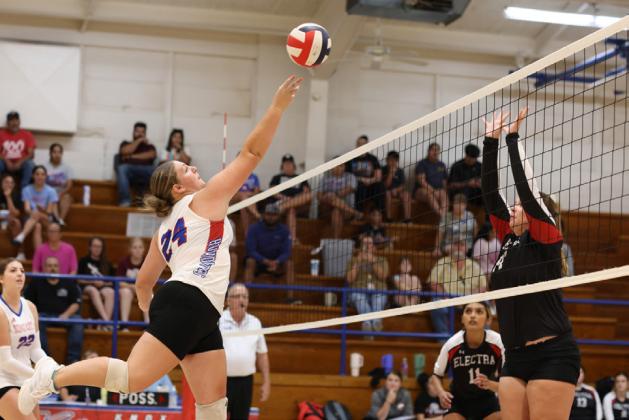 KATELEIGH CARR attacks the ball at the net for the Greyounds.