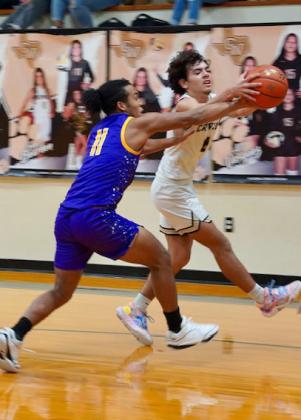 Ethan Flye attempts to steal the ball after a Mogul basket. | LACI BOWMAN PHOTO