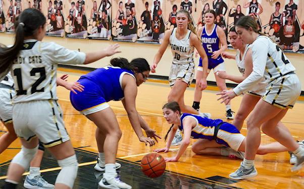 Serenity Sanchez and Kamryn Rocha scramble on the floor for a loose ball. | LACI BOWMAN PHOTO