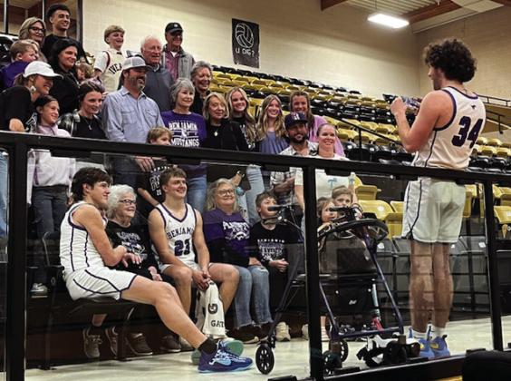 SEASON MEMORIES SeniorTallon Hayes helping out after his last game, photographing senior Hudson Cates and sophomore Everett Cates with the Cates family fan base. | SUE JANE SULLIVAN
