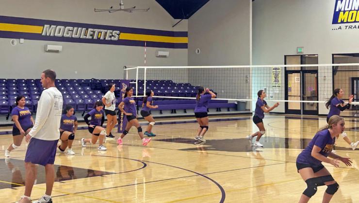 COACHES KEEP A WATCHFUL EYE on players as they progress through drills. Paying close attention to footwork makes the difference as the season progresses.