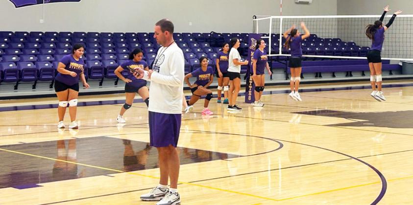 WITH 31 VOLLEYBALL PLAYERS, coaches have three groups rotating through different drills, from footwork, to blocking, to volleyball specific stretches.
