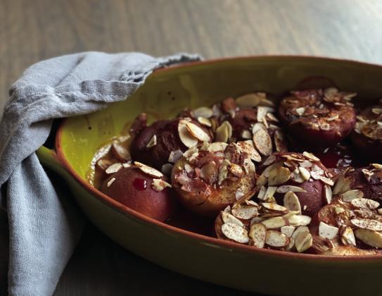 SWEET AND DELICIOUS Roasted plums with almonds make for a delightful and simple dessert or snack. This dish can be enjoyed warm, perhaps with a dollop of mascarpone or yogurt for a creamy contrast. | ANGELINA LARUE PHOTO