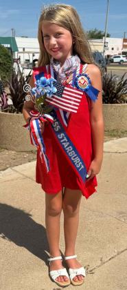 SLOAN STEWART, a student at Munday Elementary, posed with her winnings as Miss Starburst in the Little Miss Firecracker contest as part of the Munday 4th of July celebrations.