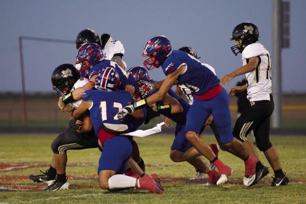 DEFENSIVE STOP The Greyhound defense makes the stop behind the line of scrimmage | SHERI BATY PHOTO