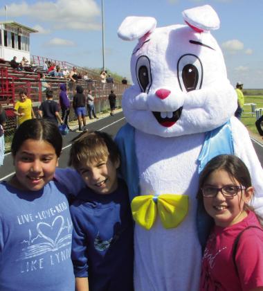 The Easter Bunny takes time to pose for a photo with local children. Don Thompson/The Knox County News-Courier
