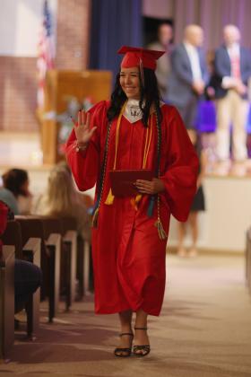 SO LONG, FAREWELL Kamryn Pepper exits the KCHS graduation with a wave to family and friends.